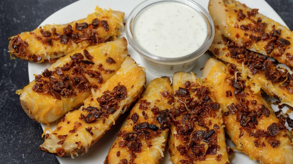 Potato Skins · Topped with cheddar jack cheese and bacon.