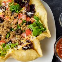 Taco Salad · Seasoned beef or chicken, cheddar jack cheese, tomatoes, and black olives in a fried tortill...