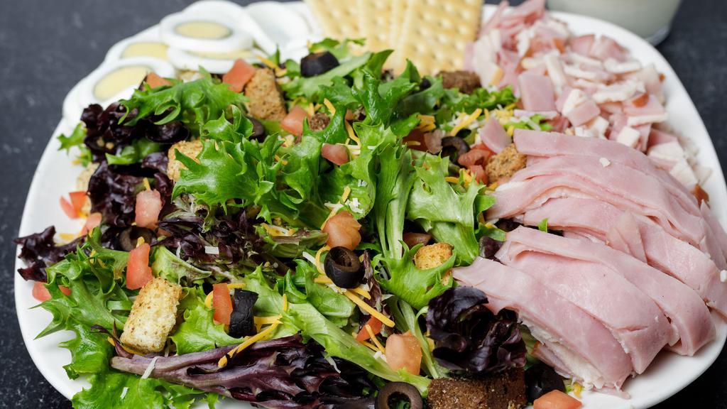 Chef Salad · Ham, turkey, cheddar jack cheese, tomatoes, black olives, croutons, and sliced egg.