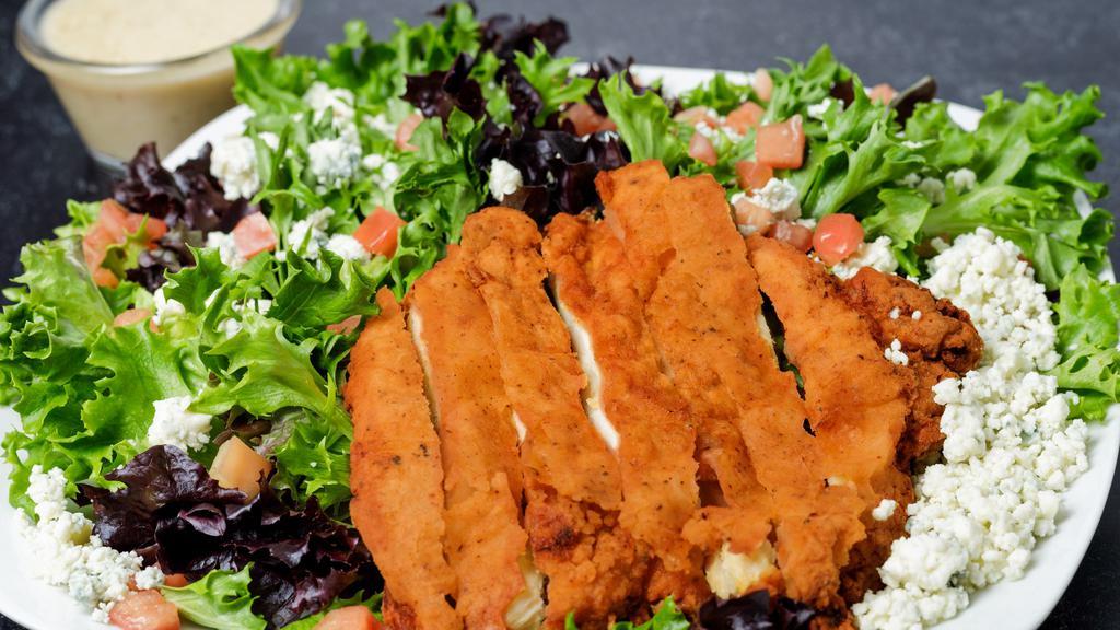 Buffalo Blue Salad · Crispy chicken tossed in hot sauce, tomatoes, and blue cheese crumbles.