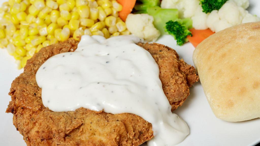 Hand Breaded Chicken Dinner · Boneless chicken breast, hand-breaded, pan-fried and smothered in gravy. Served with choice of two sides and a dinner roll.