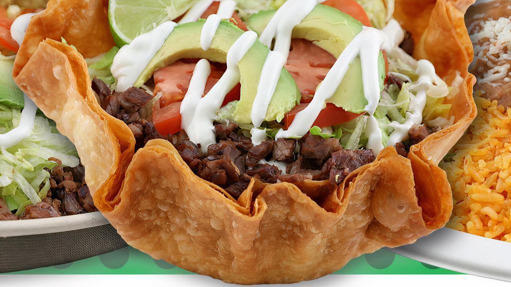 Taco Salad · Served with: meat of choice, beans, rice, sour cream, avocado, lettuce, tomato and cheese.