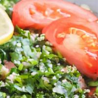 Tabouli Salad · Finely chopped parsley, with tomatoes, mint, onion, bulgur, and seasoned with olive oil, lem...