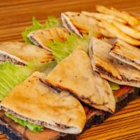 Pita Kebab · Beef stuffed pita bread, grilled, and served with garlic sauce and fries.
