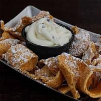 Cannoli Dip · Broken italian pastry topped with powder sugar & a chocolate drizzle. served with a side of ...
