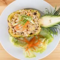 Pineapple Fried Rice · Thai jasmine rice, fresh sliced pineapple, raisin, cashew nuts, peas, carrot, green onion, w...