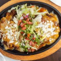 Stacked Enchiladas Dinner · Choice of sauce. Rice and Beans