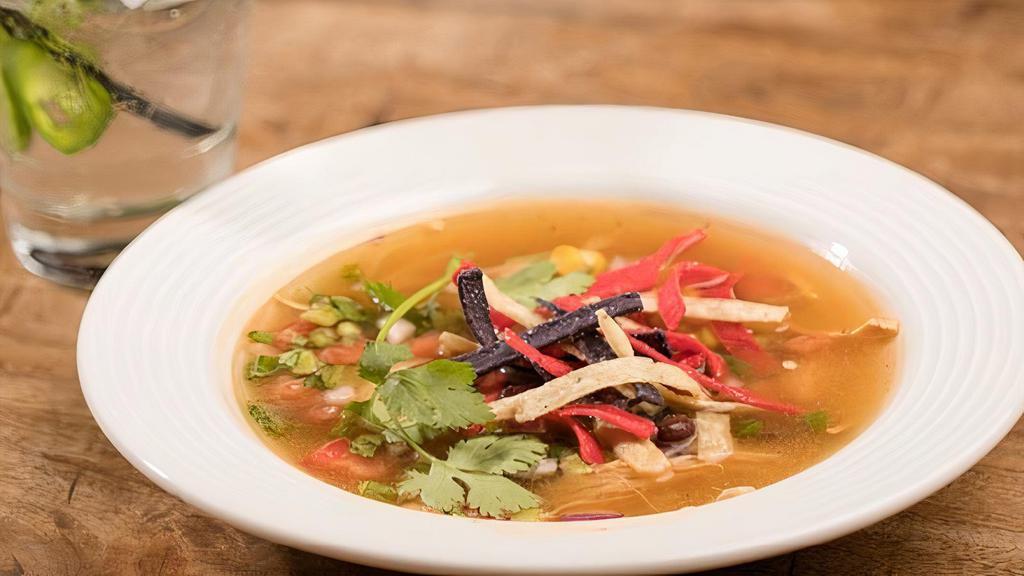 Chicken Tortilla Soup · Our from-scratch soup features tender chunks of chicken and vegetables simmered in a flavorful broth. Served with tortilla strips, cilantro and lime.