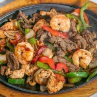 Fajitas Texanas · Favorite. Sliced steak, chicken, and shrimp grilled with bell peppers, onions, and tomatoes....