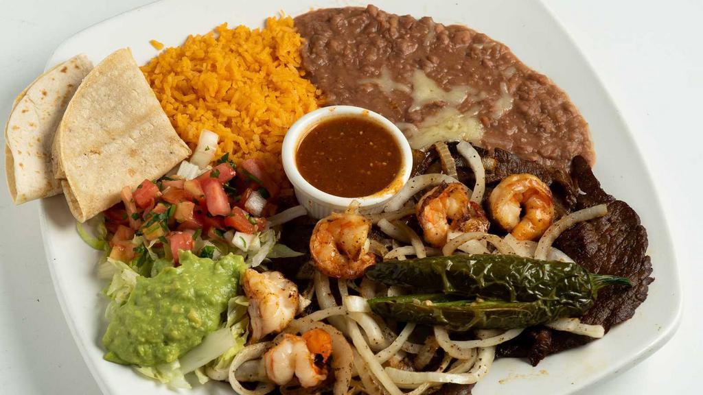 Cielo, Mar Y Tierra · Grilled steak, chicken, bacon-wrapped shrimp and pork carnitas over a bed of bell peppers and onions. Served with sour cream, salad, cilantro rice, pico de gallo and black beans.