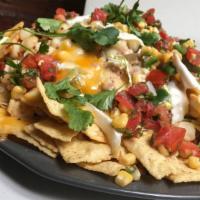 Awesome Nachos · Tortilla chips, refried beans, jack cheese, aged cheddar sauce, pickled jalapeños, pico de g...