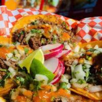 Street Tacoss · Four tasty taco with cilantro, onions and choice of meat.