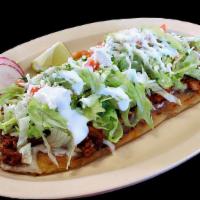 Huarache · Masa tortillas stuffed with refried beans. Topped with lettuce, cheese, sour cream and choic...