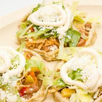 Sopes · Three masa cake topped with refried beans, lettuce, cheese, sour cream, tomato, avocado and ...
