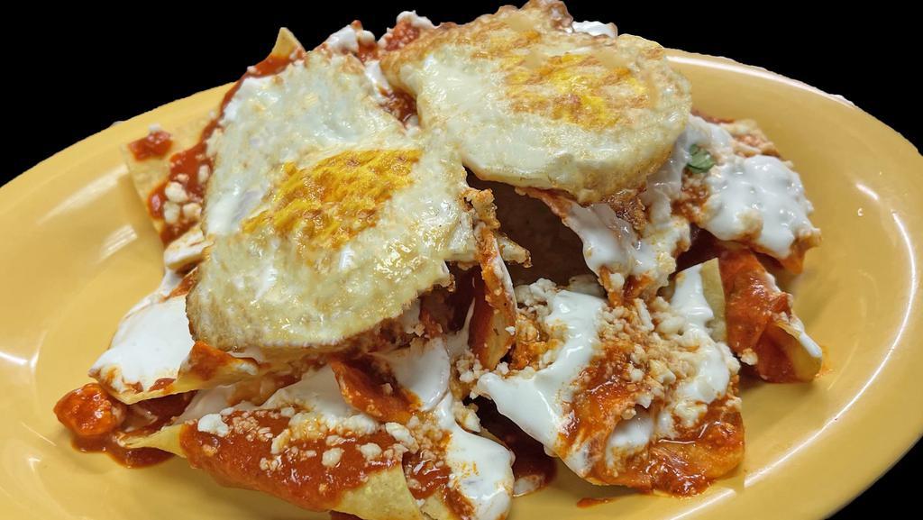 Chilaquiles Salsa Roja · Fried tortilla chips topped with salsa, cheese, sour cream, onions, eggs, and choice of meat.