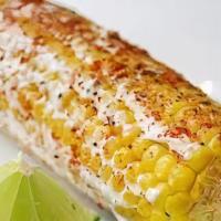 Elote · Mexican corn topped with cheese, mayonnaise, and spicy powder.