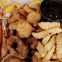 Sea Food Tray · Includes: Crab leg cluster, Breaded Shrimp, Calamari & Fries. Butter added.