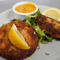 Crab Cakes · Two crispy crab cakes made with crabmeat and fresh-diced vegetables served with curry sauce.