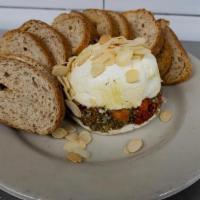 Cheese Torte · Cream cheese and goat cheese layered. with pesto and sun-dried tomatoes.. Topped with toaste...