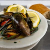 Mussels Half · A heaping crock of wine and herb-steamed mussels served with lemons and brown bread.