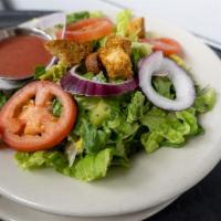 Small House Salad · Fresh greens topped with Roma tomatoes, red onion and croutons.