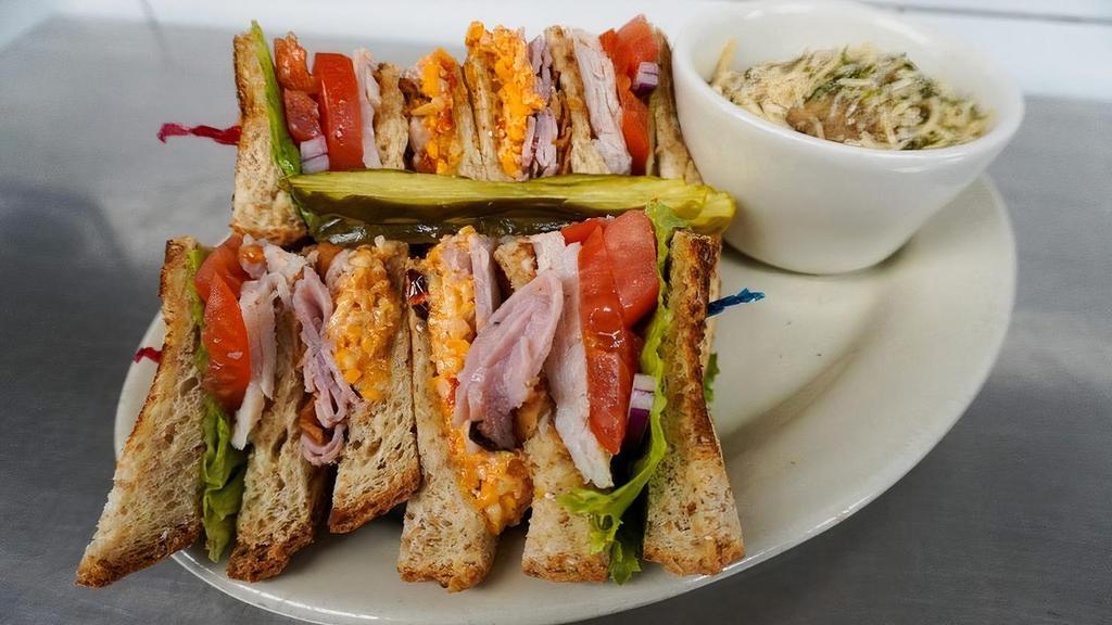 Celtic Club Sandwich · Turkey and ham, pimiento cheese, crispy bacon, lettuce, tomato and onion on toasted wheat bread.