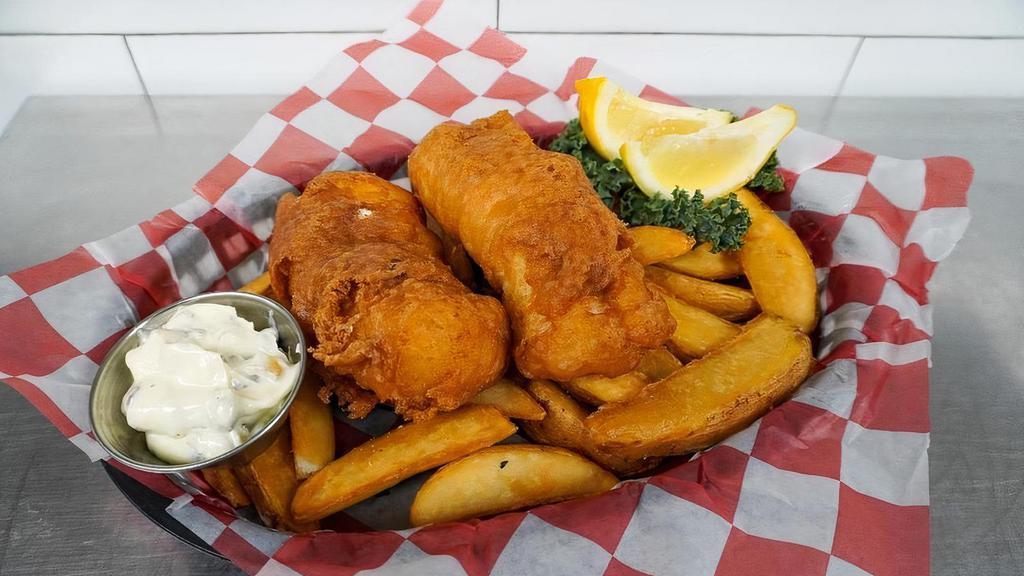 Fish And Chips · Beer-battered Icelandic Cod, fried golden brown and served with crisp potato wedges and tangy homemade tartar sauce.