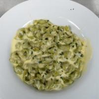 Spinach Tortellini · Half moon shaped spinach pasta filled with a creamy blend of cheeses, “Ravioli style” tossed...