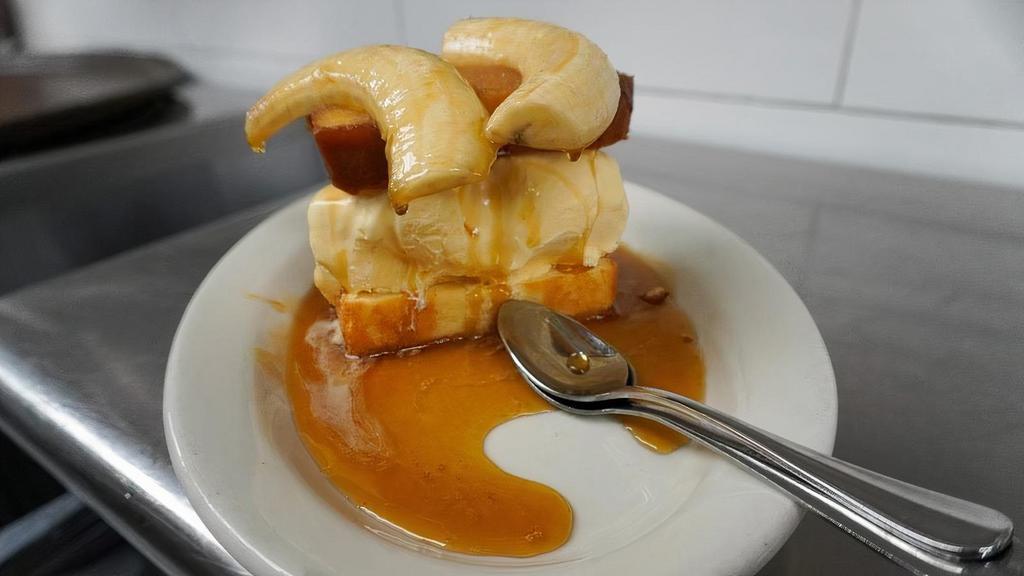 Bananas O' Foster · Vanilla ice cream between pound cake topped with flambeed banana halves and buttery, sugared rum sauce