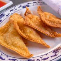 Crab Rangoon (4)  蟹饺 · Crispy deep fried wontons with a filling of crab meat and cream cheese.  Served in Four Piec...