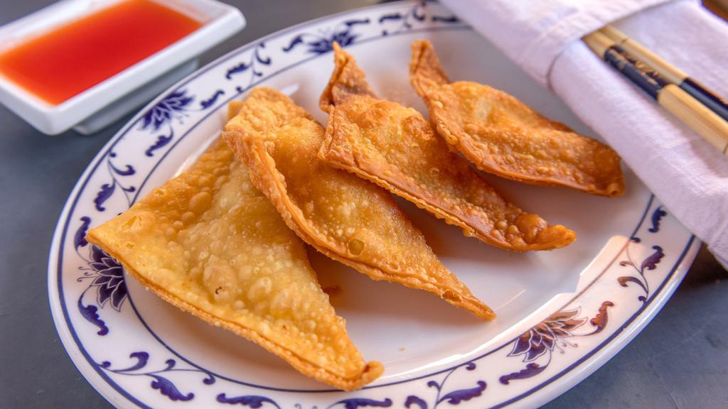Crab Rangoon (4)  蟹饺 · Crispy deep fried wontons with a filling of crab meat and cream cheese.  Served in Four Pieces.