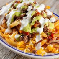 Loaded Chicken Fries · Crinkle cut fries covered in a nacho cheese sauce with grilled chicken. Topped with diced to...