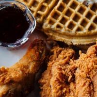 Chicken & Waffles · Fresh hand battered chicken strips over a crisp waffle served with maple syrup.