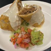 Chimichanga · Ground beef, onions, potatoes, cilantro, deep fried topped with cheese sauce, pico de gallo,...