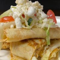 Quesadillas · Giant flour tortilla filled with chicken or beef, pork,  served with cabbage slaw, sour crea...