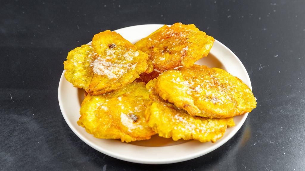 Tostones Con Ajo · Fried flattened plantains with garlic spread