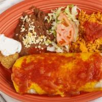 Burrito Suizo · Meat and bean burrito topped with melted cheddar cheese and ranchera sauce. Served with bean...