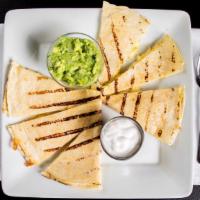 Quesadilla Appetizer · Flour tortillas stacked with melted cheese and served with sour cream and guacamole.