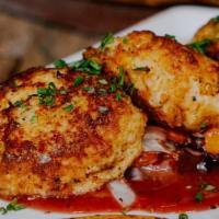 Bistro Crab Cakes · Traditional Maryland crab cakes, vegetable slaw with red wine-orange vinaigrette, and whole-...