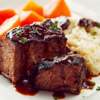 Beef Short Ribs · Tender braised beef short ribs, port wine Demi glace, roasted mushroom risotto, glazed carro...