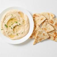- Hummus Mezze · Chickpeas blended with tahini, lemon juice & garlic. Served with freshly grilled pita bread.