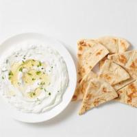 - Tzatziki Mezze · Greek yogurt with cucumbers, dill & garlic. Served with freshly grilled pita bread.