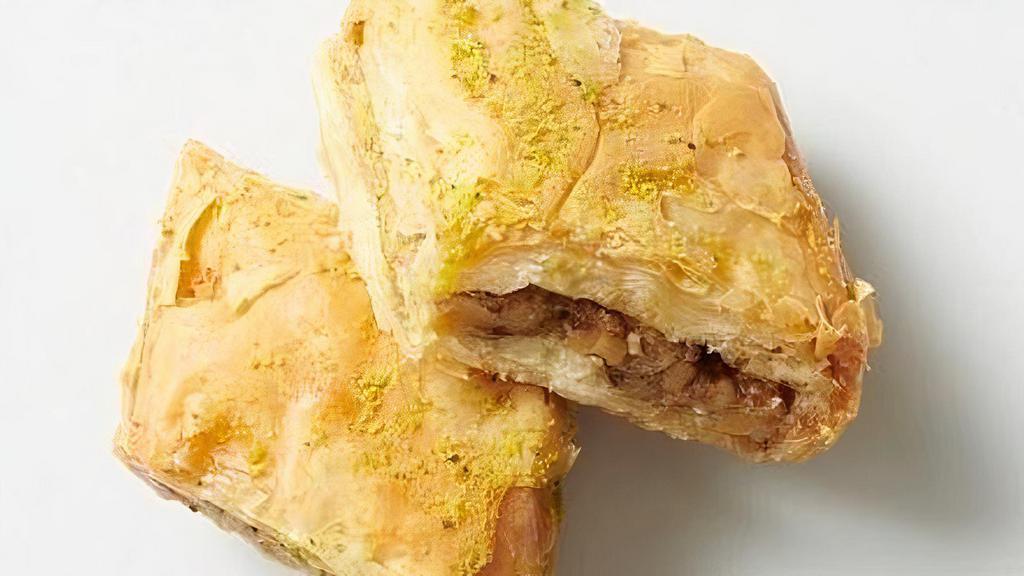 - Baklava · Layers of phyllo filled with chopped walnuts & cinnamon, drizzled with syrup & honey. (one piece)