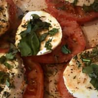 Caprese Salad · Beefsteak tomatoes, fresh mozzarella, & basil drizzled with olive oil