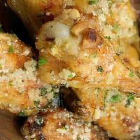 Wings - Garlic Parmesan · premium breaded wings, cooked to perfection and smothered in garlic parmesan sauce  (approx....