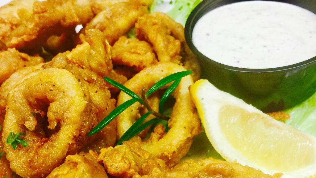 Calamari - Breaded Squid · Yianni's family recipe. A generous portion of squid, breaded using our own family recipe, cooked until golden brown. Served with our famous Greek dressing.
