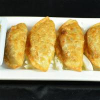 Gyoza (5) · Pan-fried pork dumplings.