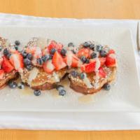 Cinnamon Swirl French Toast · Cinnamon swirl french toast, seasonal berries, and cream cheese frosting.