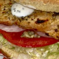 Gourmet Grilled Chicken Sandwich · A charbroiled chicken breast served on a toasted gourmet bun with garlic sauce, lettuce, tom...