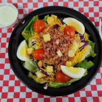 Salad · Fresh greens tossed with carrots and cabbage and topped with tomatoes, cheese, bacon, and egg.